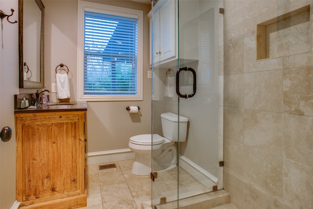 bathroom featuring vanity, toilet, tile patterned floors, and walk in shower