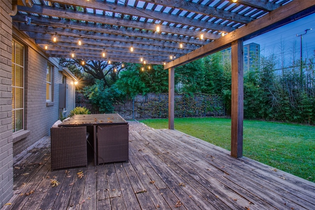 wooden deck with a yard and a pergola