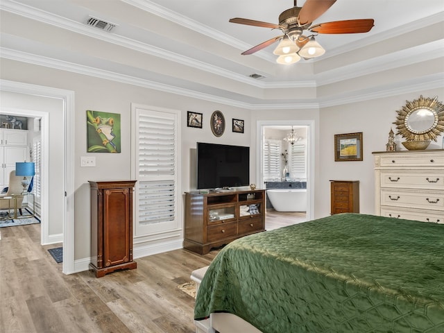 bedroom with ensuite bath, crown molding, light hardwood / wood-style floors, and ceiling fan