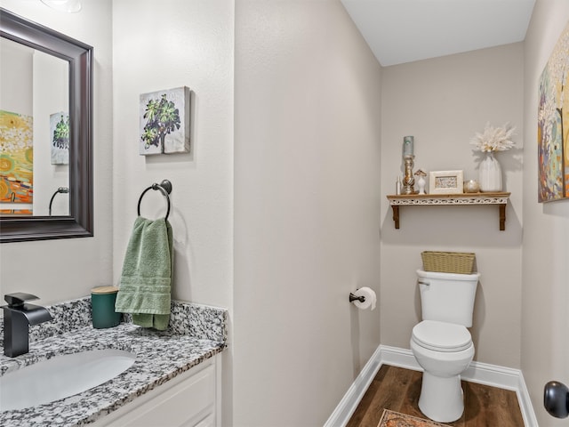 bathroom with vanity, wood-type flooring, and toilet