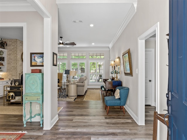 interior space featuring crown molding, hardwood / wood-style flooring, and ceiling fan