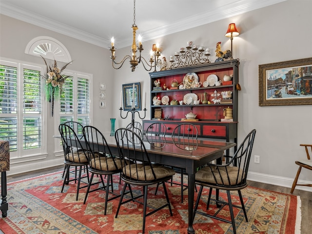 dining space featuring ornamental molding, hardwood / wood-style floors, and an inviting chandelier