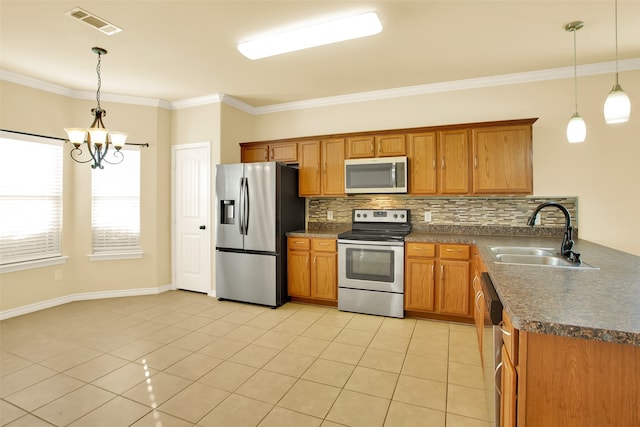 kitchen with sink, appliances with stainless steel finishes, pendant lighting, and light tile patterned flooring