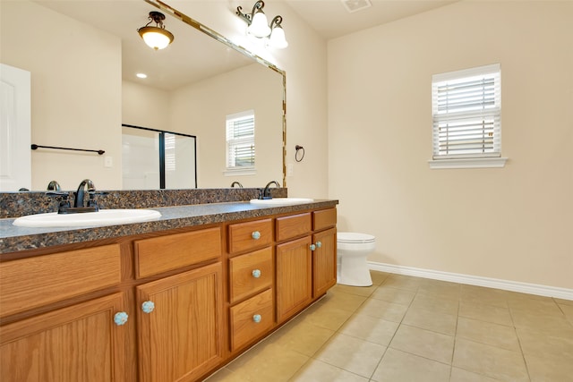 bathroom featuring vanity, walk in shower, toilet, and tile patterned flooring