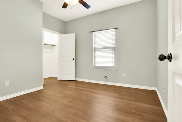 unfurnished room with wood-type flooring and ceiling fan