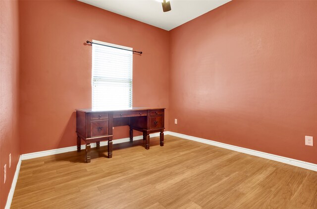 office with light hardwood / wood-style floors and ceiling fan