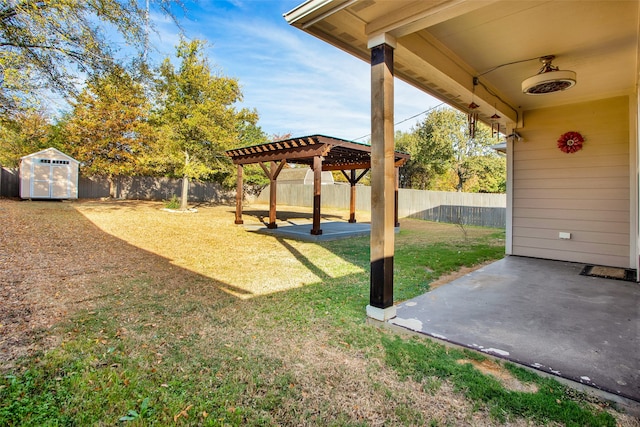 view of yard featuring a storage shed, a patio, and ceiling fan