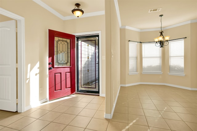 entrance foyer with ornamental molding, a chandelier, and light tile patterned flooring