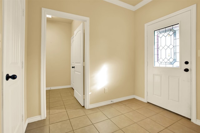 entryway featuring ornamental molding and light tile patterned floors