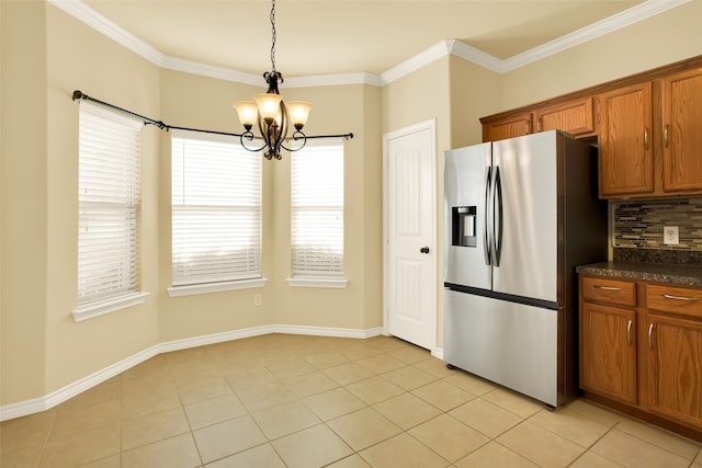 kitchen with light tile patterned floors, backsplash, stainless steel fridge with ice dispenser, and an inviting chandelier