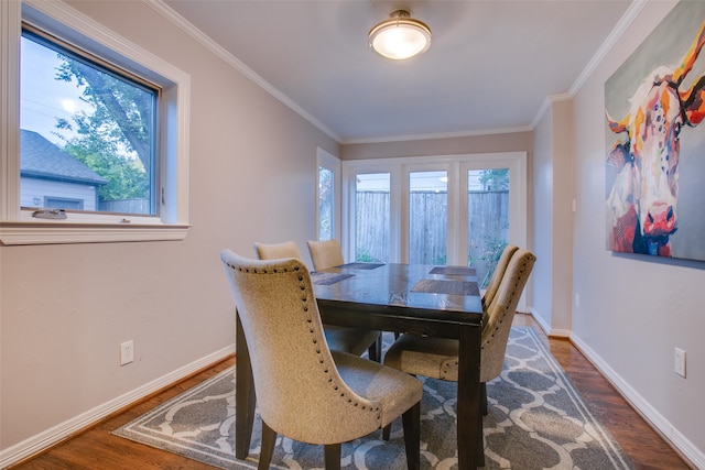 dining room featuring ornamental molding and dark hardwood / wood-style flooring