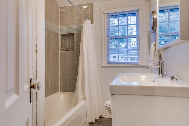 full bathroom with vanity, toilet, shower / bath combo with shower curtain, and tile patterned flooring