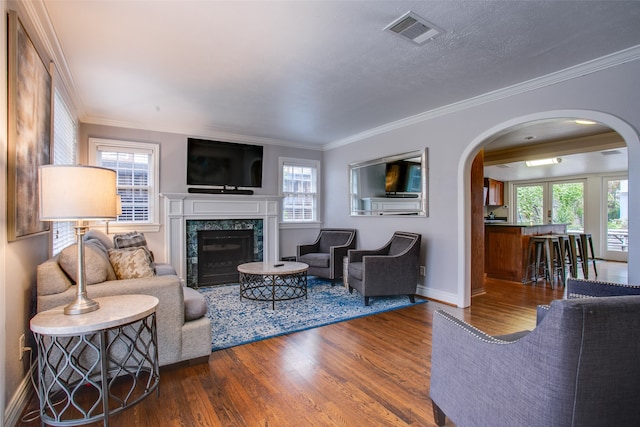 living room with ornamental molding, hardwood / wood-style floors, and plenty of natural light