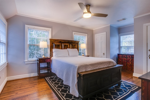 bedroom featuring multiple windows, wood-type flooring, and ceiling fan