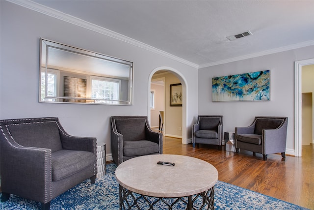 living area featuring crown molding and dark hardwood / wood-style floors