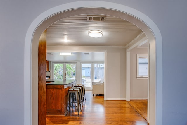 hallway featuring crown molding and hardwood / wood-style floors