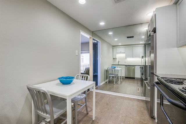 dining room featuring sink and light wood-type flooring