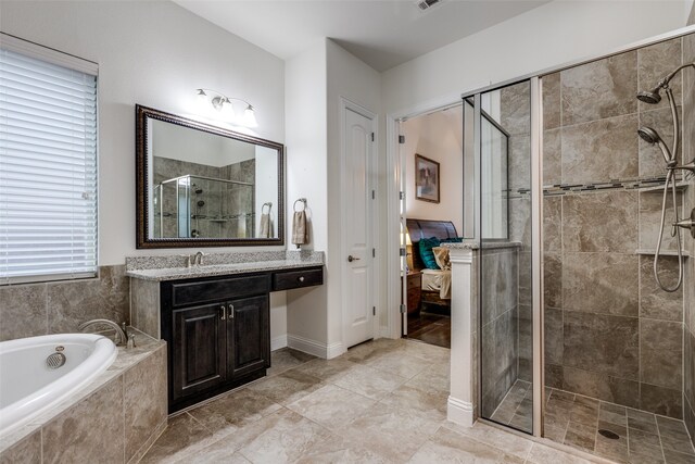 bathroom with vanity, visible vents, a shower stall, ensuite bathroom, and a garden tub