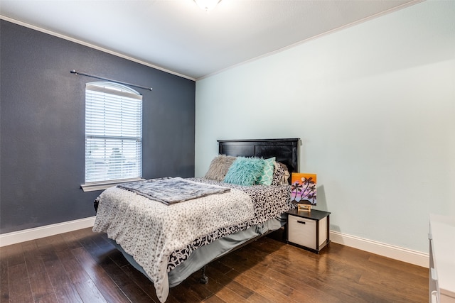 bedroom with ornamental molding, baseboards, and hardwood / wood-style floors