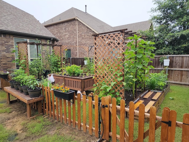 view of yard with a vegetable garden and fence