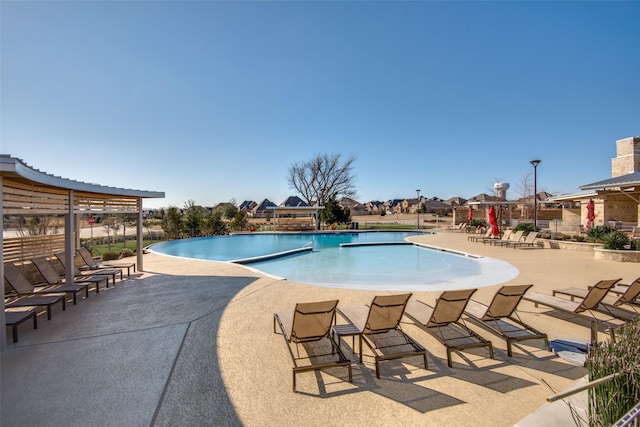 community pool with a patio area