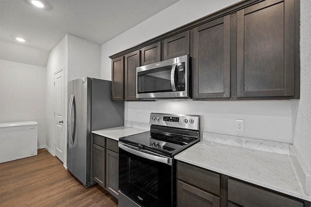 kitchen with stainless steel appliances, dark brown cabinets, and dark hardwood / wood-style floors