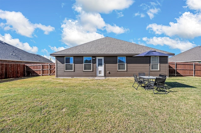 rear view of house with a yard