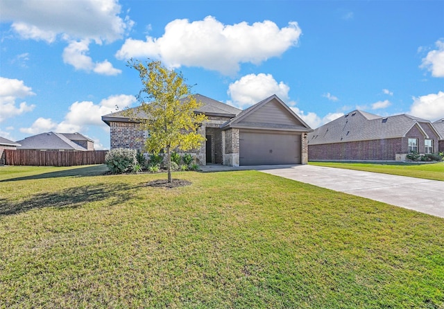 view of front of property with a front yard and a garage