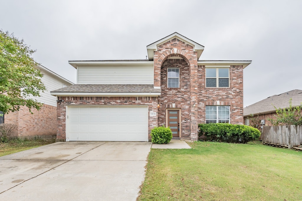 front of property featuring a front lawn and a garage