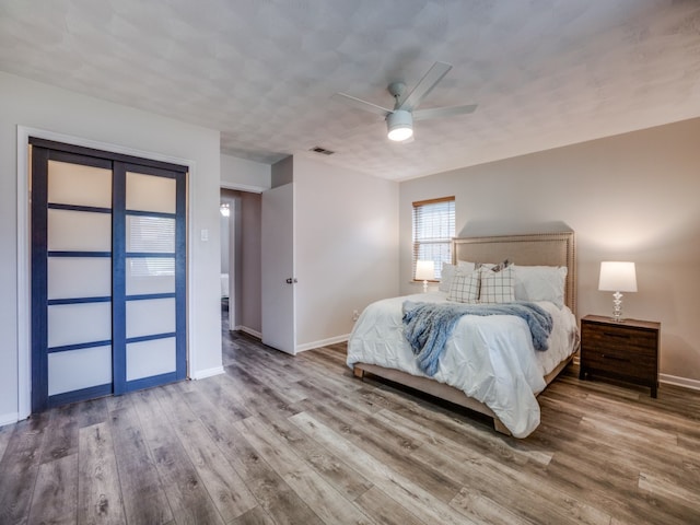 bedroom with hardwood / wood-style flooring and ceiling fan