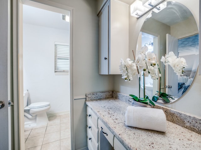 bathroom featuring vanity, toilet, and tile patterned flooring