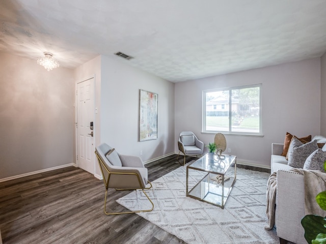 living room featuring a notable chandelier and hardwood / wood-style floors