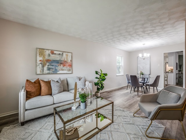 living room featuring wood-type flooring and a chandelier