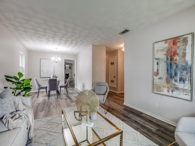 living room with a notable chandelier and wood-type flooring