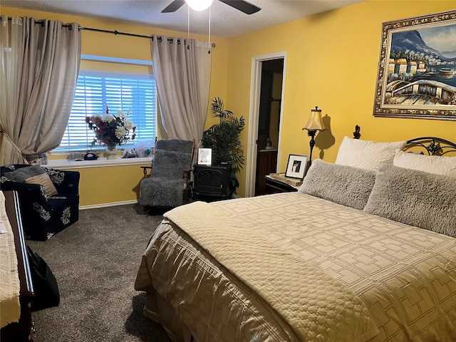 carpeted bedroom with a textured ceiling and ceiling fan