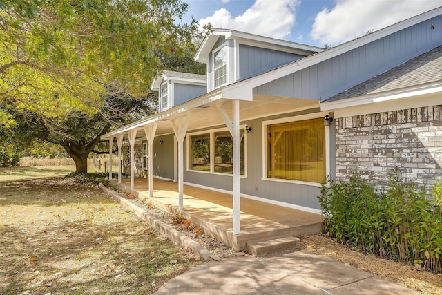 view of property exterior with covered porch