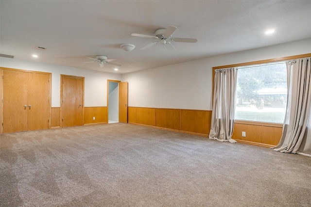 empty room with light carpet and ceiling fan