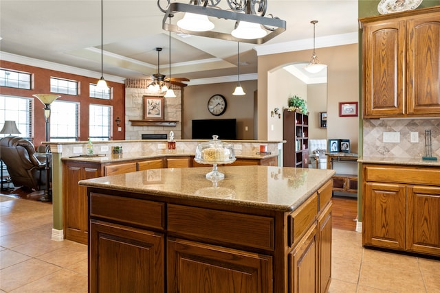 living room featuring crown molding, hardwood / wood-style flooring, and a fireplace