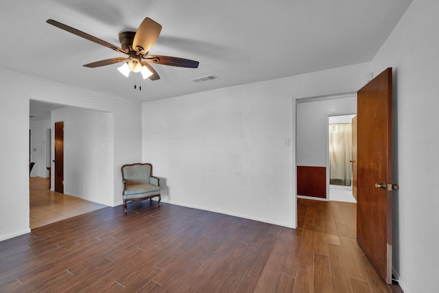 spare room with hardwood / wood-style floors and ceiling fan