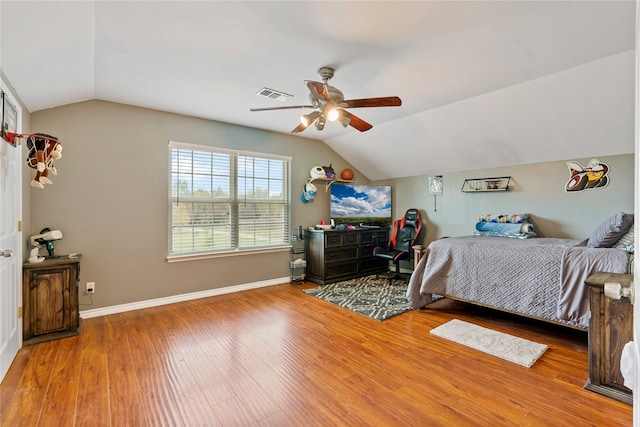 corridor with hardwood / wood-style floors and vaulted ceiling