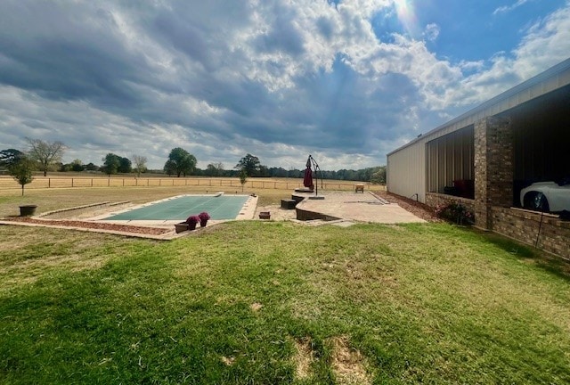 rear view of property with a yard and ceiling fan