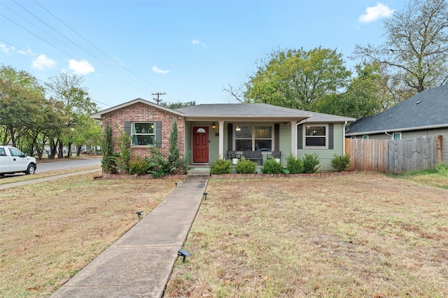 view of front of property featuring covered porch and a front lawn