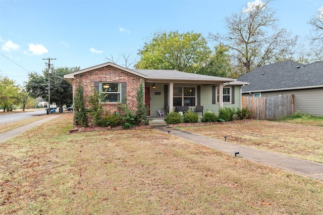 view of front of house with a front yard and a porch