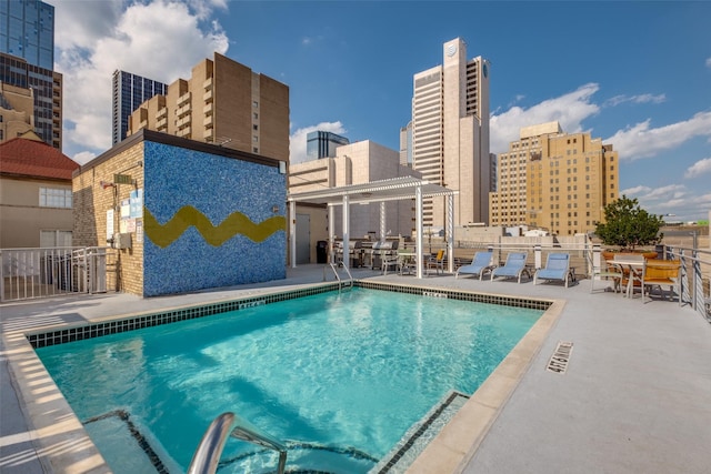 view of swimming pool with a pergola and a patio