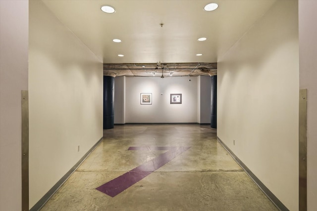 hall featuring concrete flooring