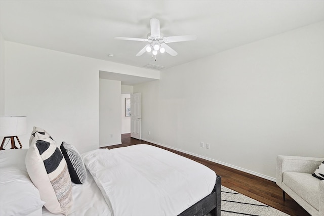 bedroom with dark wood-type flooring and ceiling fan