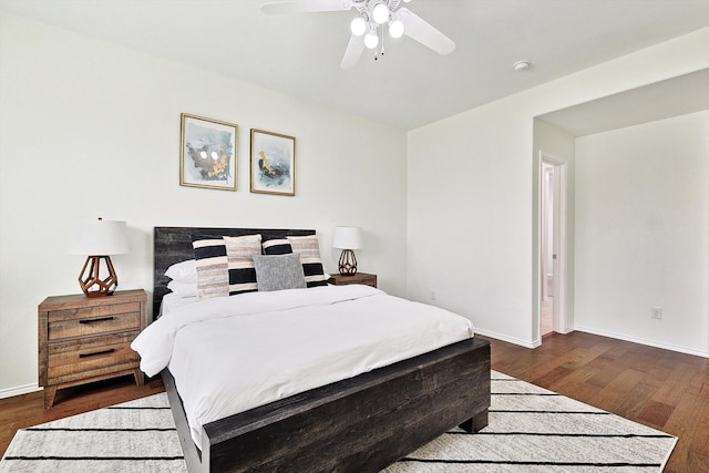 bedroom with ceiling fan and dark hardwood / wood-style flooring