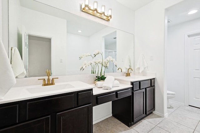 bathroom with toilet, walk in shower, vanity, and tile patterned floors