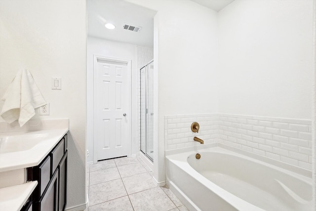 bathroom featuring vanity, shower with separate bathtub, and tile patterned floors