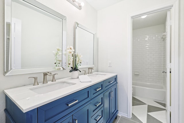 bathroom with vanity, tiled shower / bath combo, and tile patterned flooring